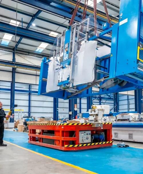 Industrial factory floor with specialized machinery in action.